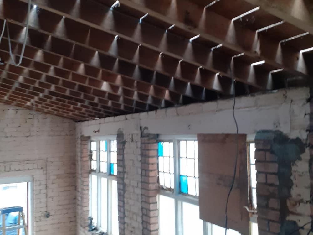 Interior stripped back to exposed ceiling joists and bare brick walls