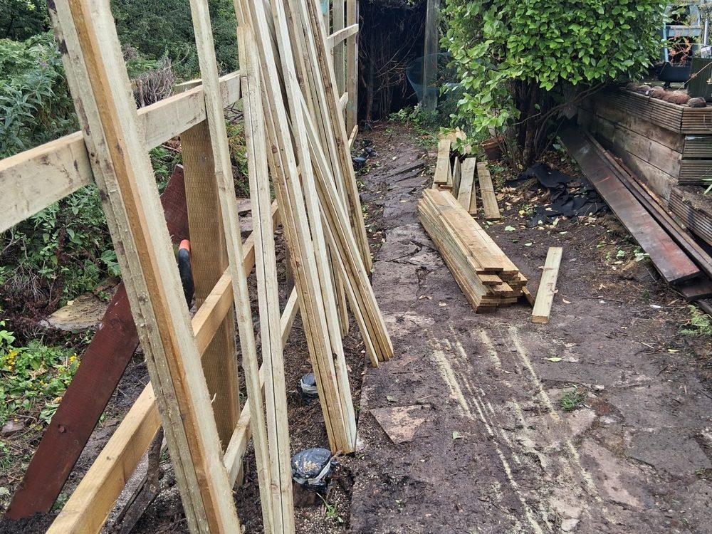Vertical fence boards stacked on site ready to be fixed to the rails