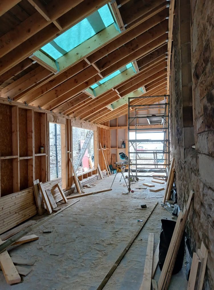 Timber-frame extension with new roof structure